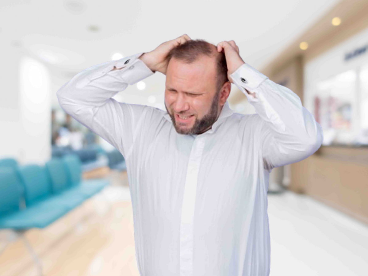A man is shown feeling frustrated and scratching his head, possibly due to discomfort or itching, against a purple background.